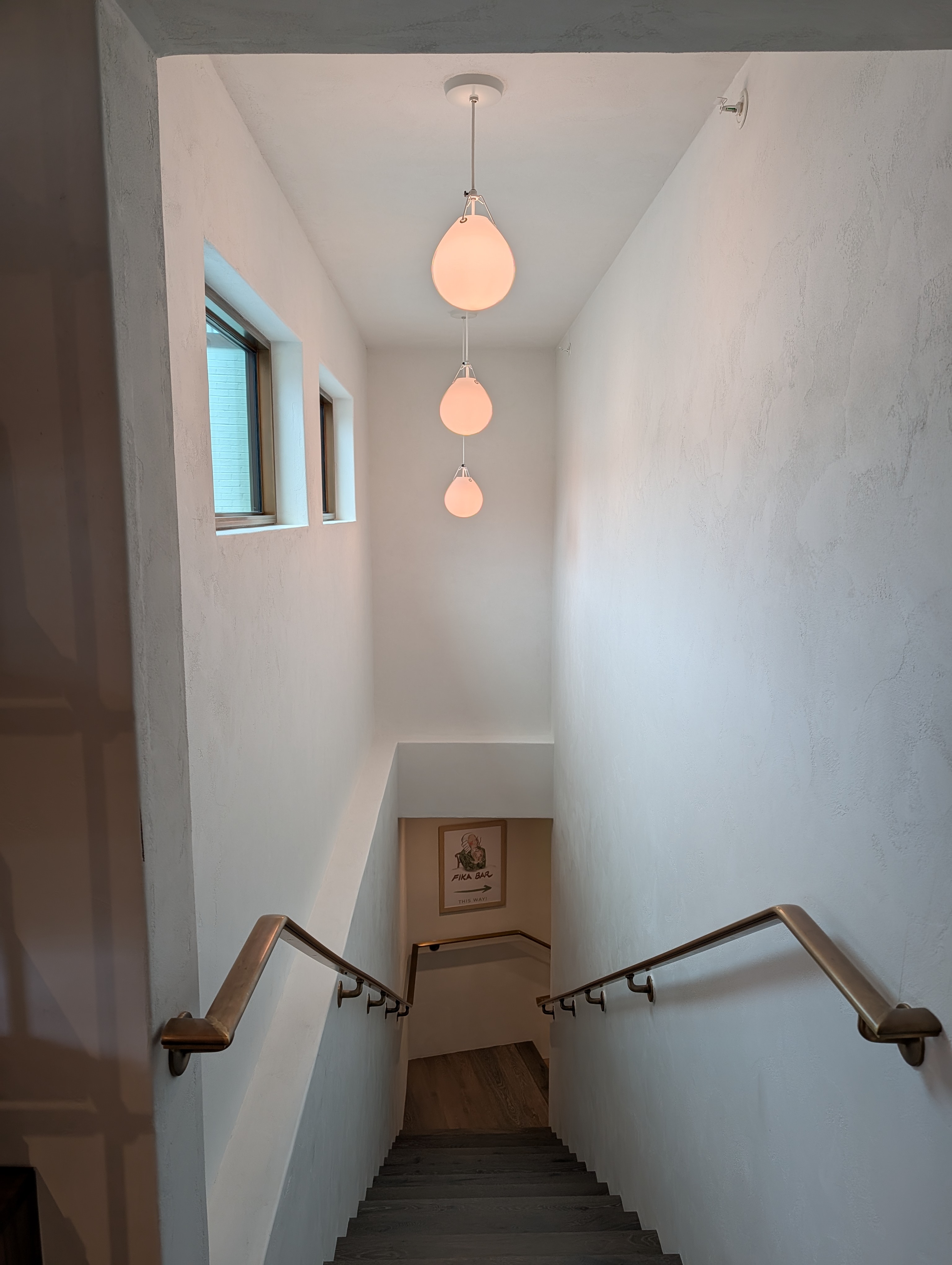 Pendant lighting installed over an interior stairway
