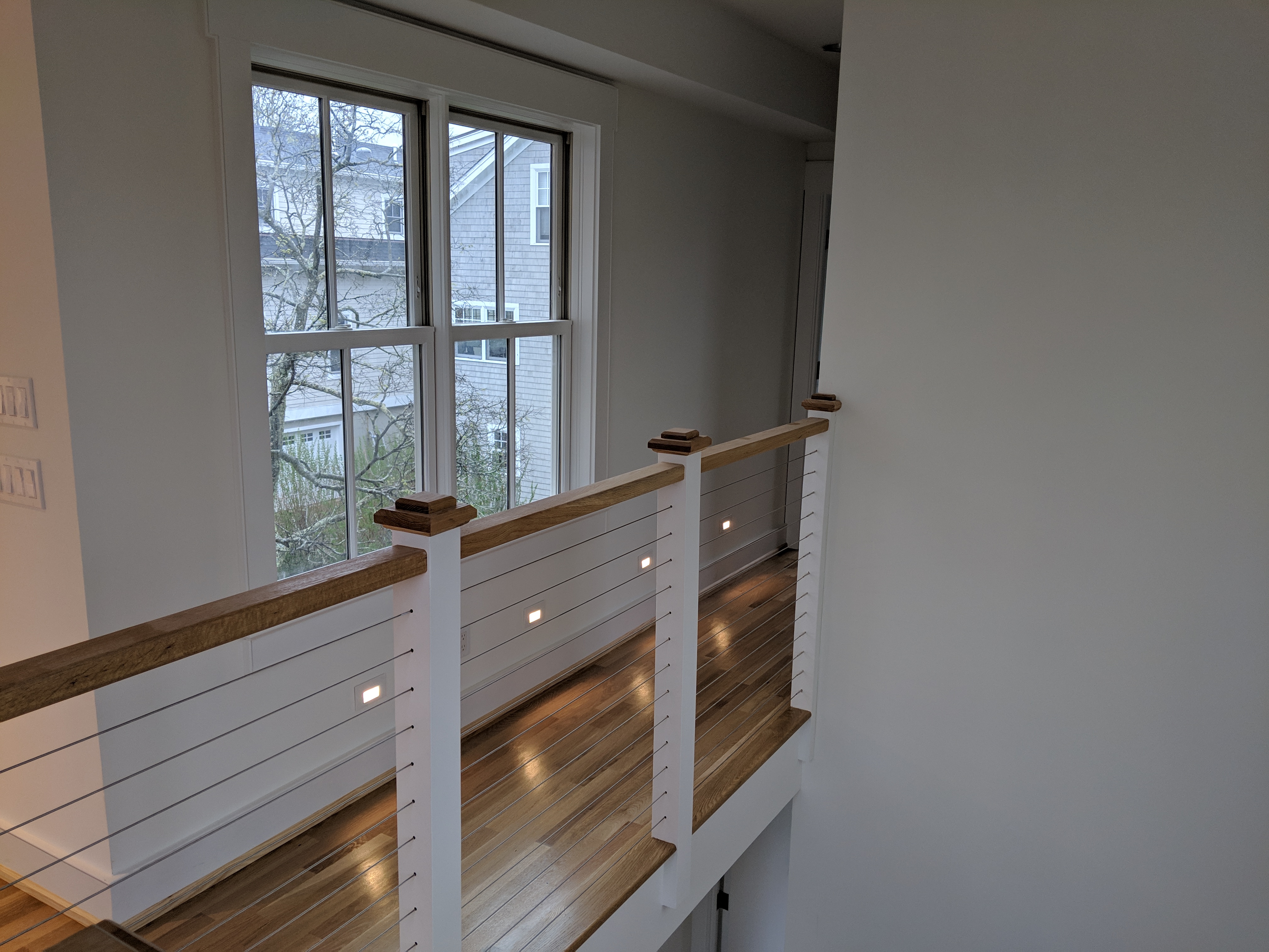 Modern stair railing with integrated low-level accent lighting