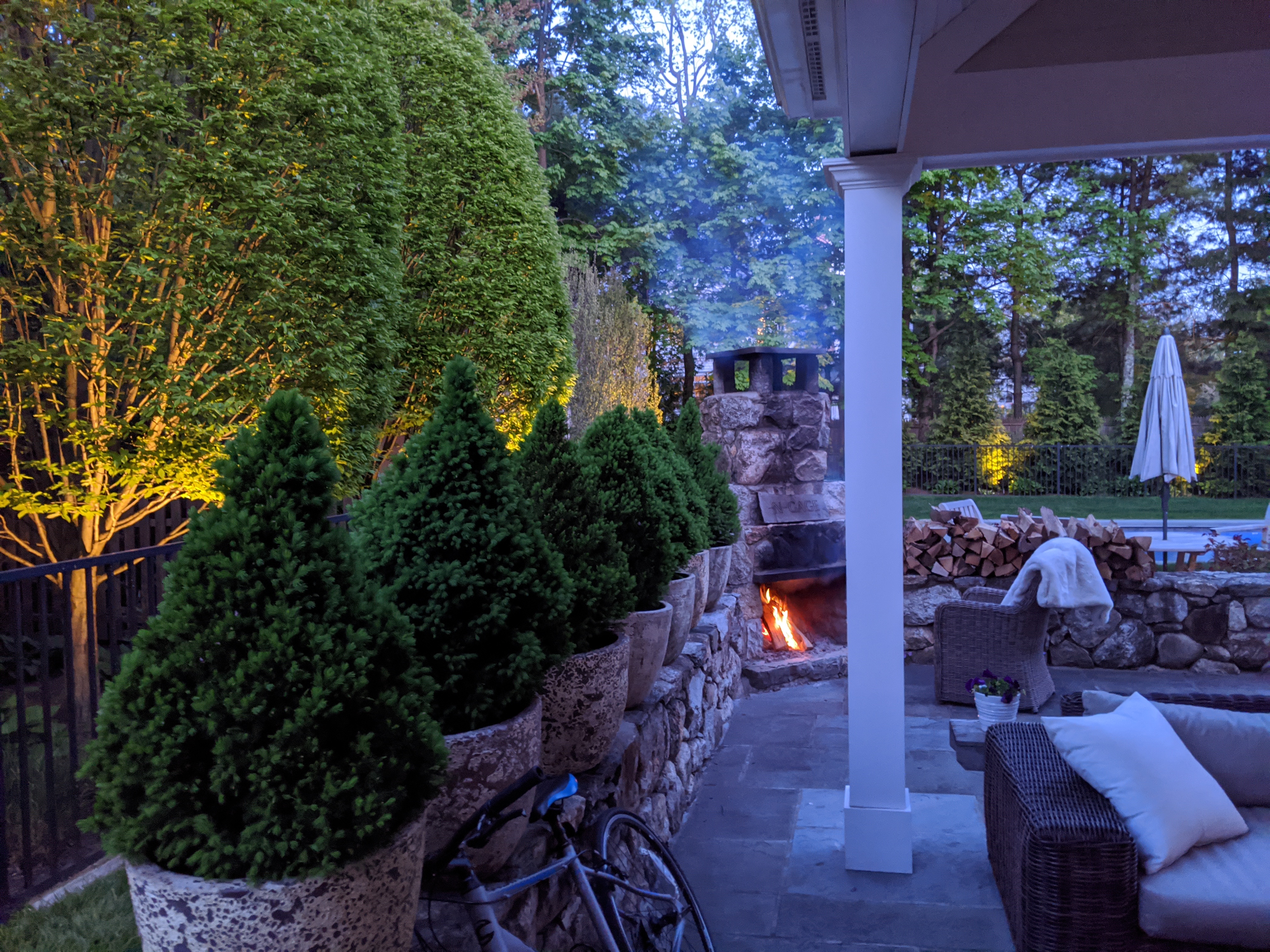 Landscape lighting illuminating outdoor trees and patio
